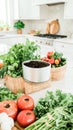 Indoor compost setup with fresh vegetables and herbs on kitchen counter Royalty Free Stock Photo