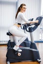 Indoor cycling woman doing cardio workout biking on indoors gym bike. Royalty Free Stock Photo