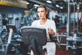 Indoor cycling woman doing cardio workout biking on indoors gym bike. Royalty Free Stock Photo