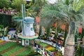 People strolling at Dutch garden exhibition with flowerbeds with colorful flowering tulips and windmill in Singapore Flower Dome.
