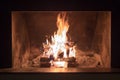 Indoor fireplace at night with bright flames