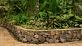 Indoor garden decorated with sandstone pavement and stone brick wall flowerbase Royalty Free Stock Photo