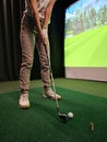 Indoor golfing practice session with a virtual simulator on a green Royalty Free Stock Photo