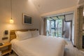 Indoor hotel room and floor-to-ceiling windows with forest view