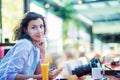 Indoor lifestyle fashion portrait of beautiful woman posing at cafe. Royalty Free Stock Photo