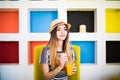 Indoor lifestyle portrait of beautiful woman posing at cafe, drinking fresh healthy tasty juice, smiling, have nice time. Royalty Free Stock Photo