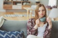 indoor lifestyle portrait of young woman relaxing at home with cup of hot tea or coffee Royalty Free Stock Photo