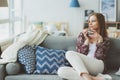 indoor lifestyle portrait of young woman relaxing at home with cup of hot tea or coffee Royalty Free Stock Photo