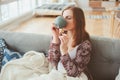 Indoor lifestyle portrait of young woman relaxing at home with cup of hot tea or coffee Royalty Free Stock Photo