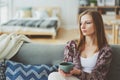 indoor lifestyle portrait of young woman relaxing at home with cup of hot tea or coffee Royalty Free Stock Photo