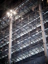 Indoor modern contemporary complex steel wall and roof construction structure inside a large building with bright illumination hig Royalty Free Stock Photo