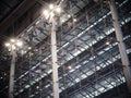 Indoor modern contemporary complex steel wall and roof construction structure inside a large building with bright illumination hig Royalty Free Stock Photo