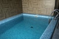 Indoor modern swimming pool in hotel spa center. The sauna finished with a light tree and pool, the laid out blue tile Royalty Free Stock Photo