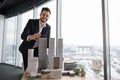 Indoor office portrait of bearded young business man, wearing white shirt and black suit Royalty Free Stock Photo