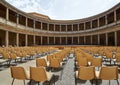 Outdoor round interior patio with chairs looking out onto an empty stage