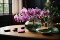 Indoor pink flower Orchid in a beautiful glass vase on a wooden table. Floral detail in interior design Royalty Free Stock Photo