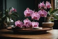 Indoor pink flower Orchid in a beautiful glass vase on a wooden table. Floral detail in interior design Royalty Free Stock Photo