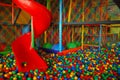 Indoor playground for kids and baby with big red slide. Royalty Free Stock Photo