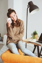 Indoor portrait of beautiful feminine thoughtful young women alone in the room with cup of tea or coffee