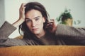 Indoor portrait of beautiful feminine thoughtful young women alone