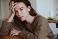 Indoor portrait of beautiful feminine thoughtful young women alone