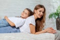 Indoor portrait of a beautiful mother with her charming little daughter posing against bedroom interior. Royalty Free Stock Photo