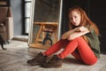 Indoor portrait of beautiful young redhead woman