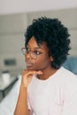 Indoor portrait of brunette young dark-skinned woman with shaggy hairstyle Royalty Free Stock Photo