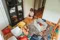 Portrait of a child playing in a very messy room