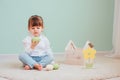 Indoor portrait of cute happy baby girl playing with easter decorations Royalty Free Stock Photo