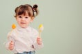 Indoor portrait of cute happy baby girl playing with easter decorations