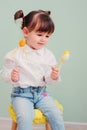 Indoor portrait of cute happy baby girl playing with easter decorations Royalty Free Stock Photo