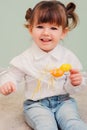 Indoor portrait of cute happy baby girl playing with easter decorations Royalty Free Stock Photo