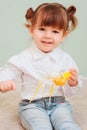 Indoor portrait of cute happy baby girl playing with easter decorations Royalty Free Stock Photo