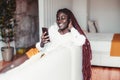 Black girl with cellphone at home Royalty Free Stock Photo