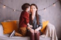 indoor portrait of happy mother and child son sitting on couch and playing Royalty Free Stock Photo