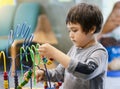 Indoor Portrait preschool boy playing in kid club with vintage tone, Child having fun playing colorful toys in kid playroom. Kid b Royalty Free Stock Photo