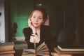 indoor portrait of redhead happy woman learning or reading books in university Royalty Free Stock Photo