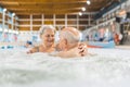 Indoor portrait of two happy caucasian grandparents relaxing in a bath and actively spending their time. Muscle tension Royalty Free Stock Photo