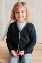 Indoor portrait of 5 years old boy with long hair sitting on table Royalty Free Stock Photo