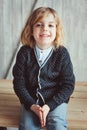 Indoor portrait of 5 years old boy with long hair sitting on table Royalty Free Stock Photo