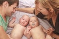 indoor portrait of young happy smiling mother and father with twin babies at home Royalty Free Stock Photo