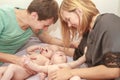 indoor portrait of young happy smiling mother and father with twin babies at home Royalty Free Stock Photo