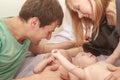 indoor portrait of young happy smiling mother and father with twin babies at home Royalty Free Stock Photo