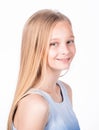 Indoor profile portrait of charming caucasian fair-haired young girl in trendy blue blouse, smiling broadly and feeling Royalty Free Stock Photo