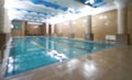 Indoor public swimming pool interior in fitness gym club Royalty Free Stock Photo