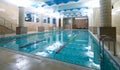 Indoor public swimming pool interior in fitness gym club Royalty Free Stock Photo