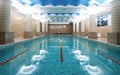 Indoor public swimming pool interior in fitness gym club Royalty Free Stock Photo