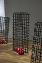 Indoor sculpture composed of iron cage and red squares