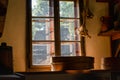 Antique room with hanging garlic, a bunch of pottery, and a dirty window. Royalty Free Stock Photo